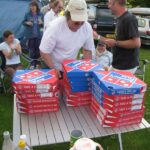 The pizza delivery boy arrives with the campsite pizzas