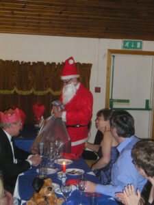 20th Dec, annual Xmas dinner, Father Paul gets ready to hand out the Secret Santa pressies ....