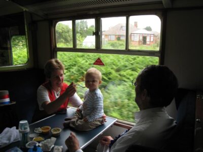 On the train, Robert was carefully secured against the train's rocking while John dozed off