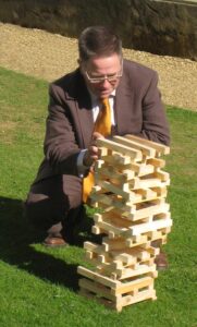 Paul attempts to master an outdoor Jenga of similar height to himself Paul attempts to master an outdoor Jenga of similar height to himself